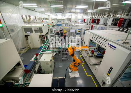 230428 -- HANGZHOU, April 28, 2023 -- A robotic arm works in a factory of Hengdian Group DMEGC Magnetics in Dongyang, east China s Zhejiang Province, April 27, 2023. Zhejiang is committed to developing future factories in its region, as a way to boost the transformation and upgrading of its manufacturing industry. The term future factory refers to a modern plant that employs digital technologies to achieve digital design, intelligent production, intelligent management, collaborative manufacturing, green manufacturing and safe control, among other things. Currently, a total of 52 future factori Stock Photo