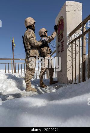 230429 -- KHUNJERAB, April 29, 2023 -- Zhou Linping R and Gao Guanghui apply paint as they renew a boundary monument in Khunjerab, northwest China s Xinjiang Uygur Autonomous Region, April 13, 2023. Gao Guanghui, a recruit who had just joined the army for 7 months, was shocked when he walked into the honor room of the border defense regiment in Khunjerab, northwestChina s Xinjiang Uygur Autonomous Region. The regiment is based on the Pamirs, guarding the China-Pakistan border and Khunjerab Port. With an average altitude of 4,700 meters, the place is a forbidden zone for many people, as the tem Stock Photo