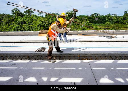 230505 -- KOTA BHARU, May 5, 2023 -- Employees work at a construction site of the East Coast Rail Link ECRL, a major infrastructure project under the Belt and Road Initiative BRI, in Kelantan, Malaysia, April 26, 2023. TO GO WITH Feature: Chinese, Malaysian youths dedication shines on BRI East Coast Rail Link megaproject  MALAYSIA-KELANTAN-BRI-MEGAPROJECT-YOUTHS ZhuxWei PUBLICATIONxNOTxINxCHN Stock Photo