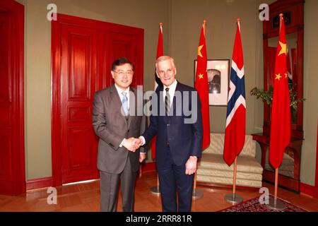 230512 -- OSLO, May 12, 2023 -- Norwegian Prime Minister Jonas Gahr Store R shakes hands with Chinese State Councilor and Foreign Minister Qin Gang during their meeting in Oslo, Norway, on May 12, 2023.  NORWAY-OSLO-PM-CHINA-QIN GANG-MEETING LinxJing PUBLICATIONxNOTxINxCHN Stock Photo