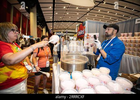 230523 -- CHICAGO, May 23, 2023 -- An attendee tries cotton candy at the Sweets and Snacks Expo in Chicago, the United States, on May 23, 2023. The 2023 Sweets and Snacks Expo is held at McCormick Place in Chicago from May 22 to May 25. Photo by /Xinhua U.S.-CHICAGO-SWEETS AND SNACKS EXPO VincentxD.xJohnson PUBLICATIONxNOTxINxCHN Stock Photo