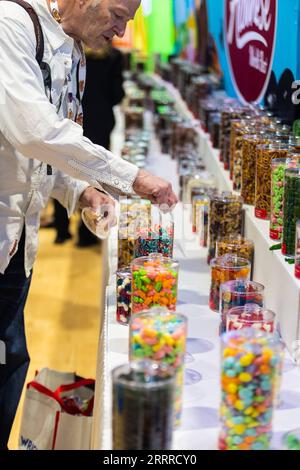 230523 -- CHICAGO, May 23, 2023 -- An attendee samples candies at a booth at the Sweets and Snacks Expo in Chicago, the United States, on May 23, 2023. The 2023 Sweets and Snacks Expo is held at McCormick Place in Chicago from May 22 to May 25. Photo by /Xinhua U.S.-CHICAGO-SWEETS AND SNACKS EXPO VincentxD.xJohnson PUBLICATIONxNOTxINxCHN Stock Photo