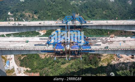 230527 -- JINSHA, May 27, 2023 -- This aerial photo taken on May 27, 2023 shows the construction site of Qingchi grand bridge in Jinsha County of Bijie City, southwest China s Guizhou Province. The bridge is a key project along the Guiyang-Jinsha-Gulin expressway. The construction of the bridge has been proceeding smoothly.  CHINA-GUIZHOU-JINSHA-BRIDGE-CONSTRUCTION CN TaoxLiang PUBLICATIONxNOTxINxCHN Stock Photo