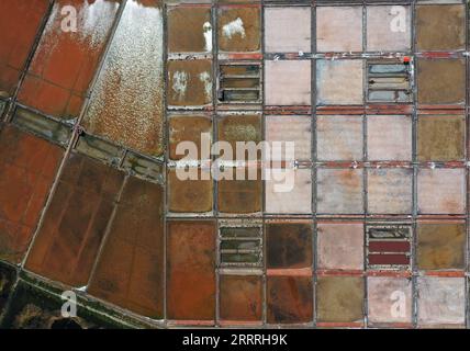 230529 -- ZHANJIANG, May 29, 2023 -- This aerial photo taken on May 28, 2023 shows the salt pans in Jiaowei Township of Xuwen County, Zhanjiang City, south China s Guangdong Province. Bordering the South China Sea on the east and the Beibu Gulf on the west and facing the Hainan Island to the south across the Qiongzhou Strait, Zhanjiang City in south China s Guangdong Province has the largest area of mangrove forest across the country and is an important base of aquatic products. In recent years, the city has put great emphasis on the development of green industries and marine economy.  SkyEyeC Stock Photo