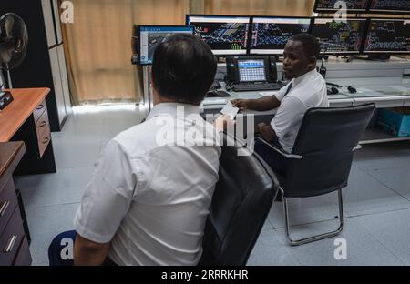 230601 -- NAIROBI, June 1, 2023 -- Chinese instructor Mao Xin L works with apprentice Peter Njenga at the Nairobi Station of the Mombasa-Nairobi Railway in Nairobi, Kenya, May 23, 2023. Mao works for the transportation department of Africa Star Railway Operation Company. He and his apprentice Peter Njenga have been working together on the dispatching plan to regulate train operation. We have brought Chinese technical standards to Kenya without reservation, and most apprentices have reached the same operating standards. Mao said that helping Kenya build the first modern railway is a highlight o Stock Photo