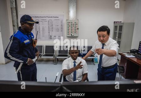 230601 -- NAIROBI, June 1, 2023 -- Chinese instructor Mao Xin R and apprentice Peter Njenga C work at the Nairobi Station of the Mombasa-Nairobi Railway in Nairobi, Kenya, May 23, 2023. Mao works for the transportation department of Africa Star Railway Operation Company. He and his apprentice Peter Njenga have been working together on the dispatching plan to regulate train operation. We have brought Chinese technical standards to Kenya without reservation, and most apprentices have reached the same operating standards. Mao said that helping Kenya build the first modern railway is a highlight o Stock Photo