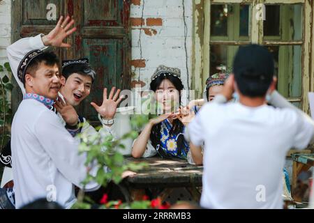 230602 -- URUMQI, June 2, 2023 -- Tourists pose for photos on Liuxing Street in Yining City, Ili Kazak Autonomous Prefecture, northwest China s Xinjiang Uygur Autonomous Region, May 17, 2023. According to comprehensive calculation through a big data platform for tourism statistics and sample survey, from January to April 2023, Xinjiang received over 51.19 million tourists, a year-on-year increase of 29.56%. Meanwhile, tourism revenue reached 42.64 billion yuan about 6.03 billion U.S. dollars, up 60.59% year on year.  CHINA-XINJIANG-TOURISM CN HaoxZhao PUBLICATIONxNOTxINxCHN Stock Photo