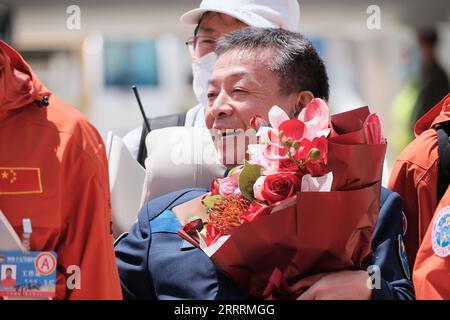 230604 -- BEIJING, June 4, 2023 -- Astronaut Deng Qingming is seen holding a bouquet from his wife after arriving in Beijing, capital of China, June 4, 2023. The three astronauts from China s Shenzhou-15 manned spaceship arrived in Beijing by plane on Sunday after their safe return to Earth following a six-month space station mission. Li Jie EyesonSciCHINA-SHENZHOU-15-RETURN CN LiuxFang PUBLICATIONxNOTxINxCHN Stock Photo