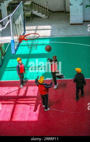 230608 -- TINGRI, June 8, 2023 -- A pupil shoots during a basketball class at a primary school of Zhaxizom Township in Tingri County, Xigaze City, southwest China s Tibet Autonomous Region, June 5, 2023. The primary school of Zhaxizom Township is the closest school to Mount Qomolangma, with a distance of just over 40 kilometers. To meet the various needs of the students, the school has established interest classes such as piano, information technology, art, broadcasting, sports, dance, and handicrafts. Currently, the primary school has only one piano. Therefore, electronic keyboards are used a Stock Photo