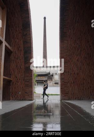 230619 -- JINGDEZHEN, June 19, 2023 -- A tourist visits Jingdezhen Imperial Kiln Institute in Jingdezhen, east China s Jiangxi Province, May 16, 2023. Jingdezhen is a world-famous porcelain capital in east China s Jiangxi Province. The city has four national-level industrial heritage sites. In the past few years, Jingdezhen has advanced the protection and utilization of industrial heritage, injecting new vitality to the city s development. The old workshops in Taoxichuan industrial heritage complex have been transformed into art museums, galleries, livestreaming workshops, traditional ceramic Stock Photo