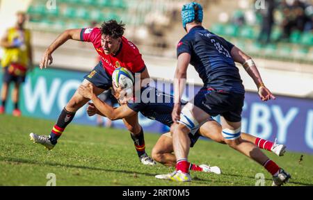 Spain Yago Fernandez charges past Hong Kong-China Oli Pyle (down) and Callum Fitzhenry during World Rugby Under 20 Trophy on July 15th 2023 played at Stock Photo