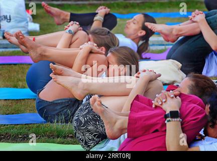 230621 -- MINSK, June 21, 2023 -- People practice yoga to mark the