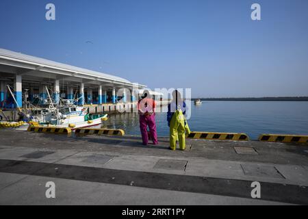 230623 -- TOKYO, June 23, 2023 -- Fishermen wait for fishing boats on a bank in Soma City, Fukushima Prefecture, Japan, March 8, 2023.  Xinhua headlines: Japan s plan to dump nuke-contaminated water into sea stokes real-life Godzilla fears ZhangxXiaoyu PUBLICATIONxNOTxINxCHN Stock Photo