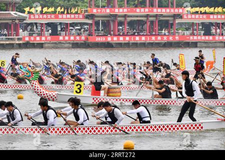 230624 -- FUZHOU, June 24, 2023 -- People compete in a dragon boat race which has participants from both sides of the Taiwan Strait, in Xiamen of southeast China s Fujian Province, on June 3, 2023. The Dragon Boat Festival, also known as Duanwu Festival, traditionally falls on the fifth day of the fifth month in the Chinese lunar calendar. The dragon boat competition, a traditional part of the festival, has gained popularity on both sides of the Taiwan Strait, bringing excitement to a wide range of people. Located on the southeastern coast of China, Fujian Province is ideal for water sports wi Stock Photo