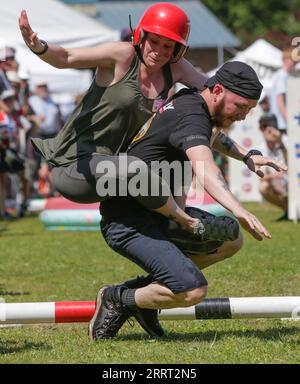 230626 -- BURNABY, June 26, 2023 -- A contestant and his wife fall at the obstacle course as they take part in a wife-carrying contest in Burnaby, British Columbia, Canada, on June 25, 2023. Photo by /Xinhua CANADA-BURNABY-WIFE-CARRYING CONTEST LiangxSen PUBLICATIONxNOTxINxCHN Stock Photo