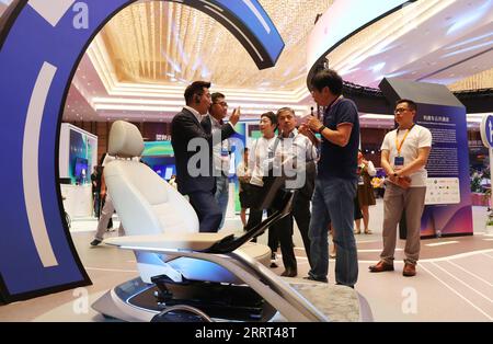 SHANGHAI, CHINA - JUNE 28, 2023 - Sales staff line up canvas bags and books  with the Louis Vuitton brand LOGO at the entrance of a Louis Vuitton coffe  Stock Photo - Alamy