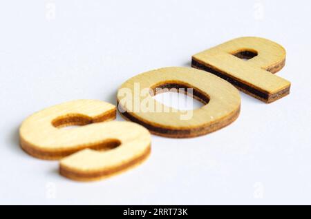 SOP wooden text on white notepad. Standard operating procedure concept. Stock Photo