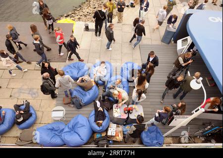 Young people relaxing on beanbags at the lounge zone. July, 3, 2013. Kiev, Ukraine Stock Photo