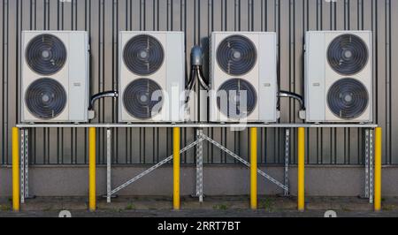 Multiple Air Conditioner Units on Building Exterior for Efficient Cooling Stock Photo