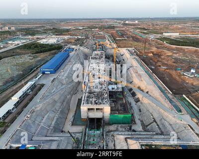 230707 -- XIONG AN, July 7, 2023 -- This aerial photo taken on July 4, 2023 shows the construction site of the financial island station on an express line linking Xiong an with Beijing Daxing International Airport R1 line in the start-up area in Xiong an New Area, north China s Hebei Province. China announced plans to establish the Xiong an New Area on April 1, 2017, located about 100 km southwest of Beijing, aiming to build the area into a national model of high-quality development and a new engine for the modern economic system. The Political Bureau of the Communist Party of China CPC Centra Stock Photo