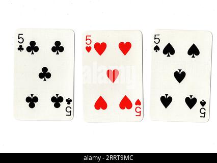 Vintage playing cards showing three fives on a white background. Stock Photo