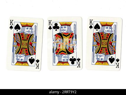 Vintage playing cards showing three kings on a white background. Stock Photo