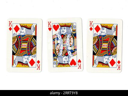 Vintage playing cards showing three kings on a white background. Stock Photo