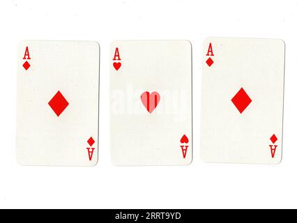 Vintage playing cards showing three aces on a white background. Stock Photo