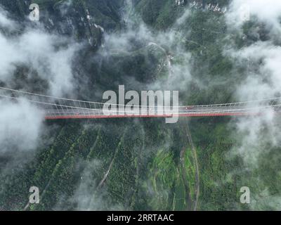 230709 -- JISHOU, July 9, 2023 -- This aerial photo taken on July 8, 2023 shows the Aizhai suspension bridge in Xiangxi Tujia and Miao Autonomous Prefecture, central China s Hunan Province.  CHINA-HUNAN-HIGHWAY-BRIDGE-AERIAL VIEW CN ZhaoxZhongzhi PUBLICATIONxNOTxINxCHN Stock Photo
