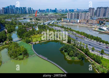 230713 -- CHENGDU, July 13, 2023 -- This aerial photo taken on June 23, 2023 shows the Jinjiang park along the Jinjiang River in Chengdu, capital of southwest China s Sichuan Province. Jinjiang River traverses the central part of Chengdu, contributing to the fame and glamor of Chengdu s many historic and cultural events. It has two main streams called Fuhe River and Nanhe River. Starting from Dujiangyan, the 150-km river goes outbound from Shuangliu District. In February of 2016, local government of Chengdu implemented ten regulations on water control. In 2017, the city started a program on wa Stock Photo