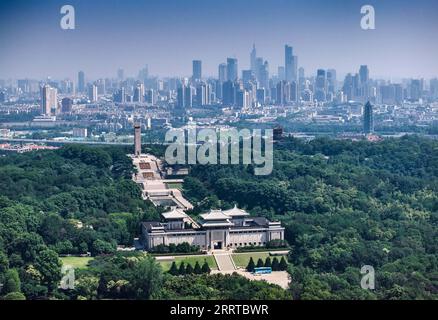 230714 -- NANJING, July 14, 2023 -- This aerial photo taken on June 9, 2023 shows the Yuhuatai memorial park of martyrs and the city view in Nanjing, east China s Jiangsu Province. The ancient city Nanjing, with a history of around 2,500 years, has started many renewal projects along the Qinhuai River in recent years. This has helped bring the old and new together to create a brighter future of the city. Such urban renewal projects have also led to the prosperity of the cultural sector in the ancient city. In 2022, the added value of Nanjing s cultural industry reached 112 billion yuan about 1 Stock Photo