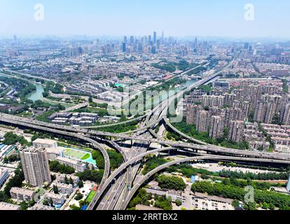 230714 -- NANJING, July 14, 2023 -- This aerial photo taken on June 9, 2023 shows the Shuangqiaomen interchange junction and the city wall of Ming Dynasty 1368-1644 in Nanjing, east China s Jiangsu Province. The ancient city Nanjing, with a history of around 2,500 years, has started many renewal projects along the Qinhuai River in recent years. This has helped bring the old and new together to create a brighter future of the city. Such urban renewal projects have also led to the prosperity of the cultural sector in the ancient city. In 2022, the added value of Nanjing s cultural industry reach Stock Photo