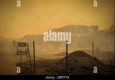 Bilder des Jahres 2023, News 07 Juli 230723 -- RHODES ISLAND, July 23, 2023 -- This photo taken on July 22, 2023 shows smoke caused by a massive wildfire in the Rhodes island in Greece. At least 2,000 residents and holidaymakers were evacuated by sea in the fire-stricken areas of Rhodes island in Greece on Saturday evening, authorities said. Photo by /Xinhua GREECE-RHODES ISLAND-WILDFIRE ArgirisxMantikos PUBLICATIONxNOTxINxCHN Stock Photo