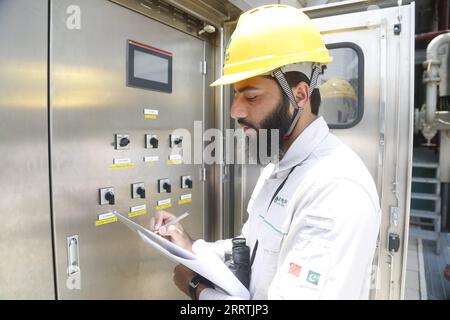 230728 -- LAHORE, July 28, 2023 -- Zubair Tufail checks the operation of equipment at a converter station of À660 kilovolt Matiari-Lahore high-voltage direct current HVDC transmission project in a suburb of Lahore, Pakistan, July 4, 2023. TO GO WITH Feature: China-Pakistan power project facilitates economic growth, cements friendship  PAKISTAN-CHINA-POWER PROJECT-FRIENDSHIP AhmadxKamal PUBLICATIONxNOTxINxCHN Stock Photo