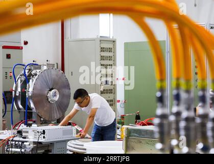 230727 -- GUANGZHOU, July 27, 2023 -- A researcher operates equipment at the accelerator radio frequency technology laboratory of China Spallation Neutron Source CSNS in Dongguan, south China s Guangdong Province, July 18, 2023. In the city of Dongguan lies a world-class sci-tech project -- China Spallation Neutron Source CSNS. Over 1,000 research tasks have been tackled since it started in August 2018. Dubbed as a super microscope, a spallation neutron source can produce and accelerate protons before smashing them into the target to produce neutrons, and the neutron beams will be directed to Stock Photo