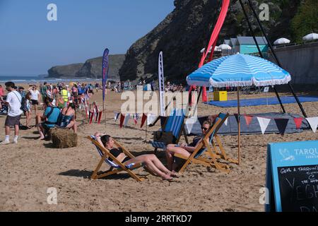 Watergate Bay, Cornwall, UK. 9th September 2023. UK Weather.  Sunbathers on the beach at Watergate bay, at the start of the weekend long arts on the beach event. Credit SImon Maycock / Alamy Live News. Stock Photo