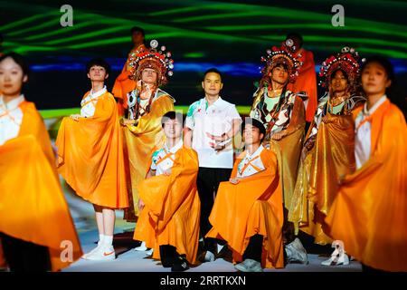 230729 -- CHENGDU, July 29, 2023 -- Kang Yong C, leader as well as director of bian lian performing squad, pose with other performers during an opening ceremony rehearsal in Chengdu of southwest China s Sichuan Province, on July 8, 2023. Ren Xin, a 19-year-old college student, was fascinated with dancing since her childhood. She was one of the actors and actresses who performed the traditional bian lian , or face-changing during the opening ceremony of the 31st FISU Summer World University Games in Chengdu on July 28, 2023. Ren Xin, who was born in a remote mountain village called Changsheng C Stock Photo