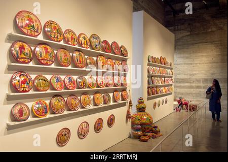 230801 -- DHAKA, Aug. 1, 2023 -- A visitor views artworks displayed at an exhibition titled Folk Art of Bangladesh: Illustrated Pottery in Dhaka, Bangladesh, on Aug. 1, 2023. BANGLADESH-DHAKA-FOLK ART EXHIBITION Salim PUBLICATIONxNOTxINxCHN Stock Photo