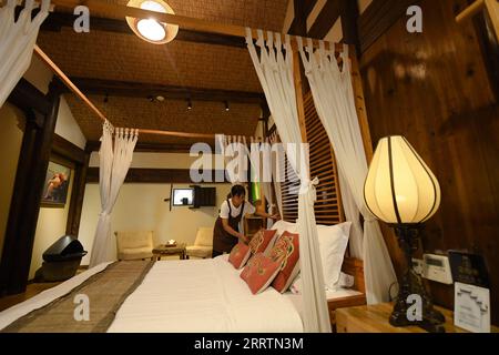 230802 -- JINHUA, Aug. 2, 2023 -- A staff member cleans up a room at a homestay in Zhuge Village of Lanxi City, east China s Zhejiang Province, Aug. 1, 2023. The Zhuge Village, a historic gem with over 300 ancient buildings dating back to Ming and Qing dynasties 1368-1911, is home to descendents of Zhuge Liang, a renowned military strategist in the Three Kingdom Period 220-280. The village has made concerted efforts to preserve the ancient heritages and develop tourism, receiving over 500,000 visitors annually.  ZhejiangPictorial CHINA-ZHEJIANG-VILLAGE-ANCIENT BUILDING CN WengxXinyang PUBLICAT Stock Photo