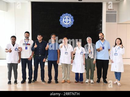 230803 -- NANJING, Aug. 3, 2023 -- Fan Zhining C and Liu Li 4th R, experts of digestive endoscopy, pose for photos with foreign medical workers of a medical seminar at Jiangsu Province Hospital in Nanjing, capital of east China s Jiangsu Province, Aug. 1, 2023. In recent years, Jiangsu Province Hospital cooperated with medical institutions in Pakistan, Egypt and other countries and regions in the field of digestive endoscopy to promote medical cooperation under the Belt and Road Initiative.  CHINA-JIANGSU-DIGESTIVE ENDOSCOPY-INTERNATIONAL COOPERATION CN JixChunpeng PUBLICATIONxNOTxINxCHN Stock Photo