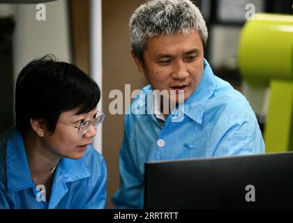 230808 -- HEFEI, Aug. 8, 2023 -- Peng Chengzhi R checks experimental data with Professor Yin Juan at a laboratory of the Shanghai Institute for Advance Studies of the University of Science and Technology of China in east China s Shanghai, July 22, 2023. Peng Chengzhi, born in 1976, holds several professional positions: professor and doctoral supervisor at the University of Science and Technology of China USTC, chief scientist of QuantumCTek Co., Ltd., and chief engineer of the scientific application system of Micius, the world s first quantum communication satellite. Peng began to participate Stock Photo