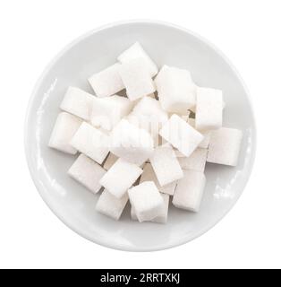 White plate with sugar cubes on a white background. View from above. Sugar Stock Photo