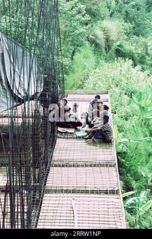 A group of male Indonesian builders having a rest at a construction site Stock Photo