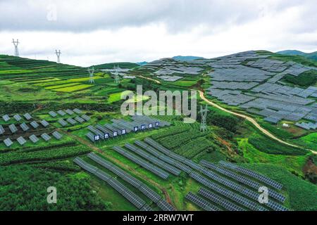 230815 -- GUIYANG, Aug. 15, 2023 -- This aerial photo taken on July 20, 2023 shows a photovoltaic power plant in Yi-Hui-Miao Autonomous County of Weining, southwest China s Guizhou Province. Guizhou has seized the opportunity and made big stride in the development of new energy industry, such as wind power and photovoltaic power, in recent years. While vigorously developing green energy, Guizhou has also made full use of the land under photovoltaic panels to develop farming and livestock breeding. By the end of June 2023, the total installed capacity of new energy in Guizhou had reached 21.81 Stock Photo