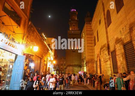 230818 -- BEIJING, Aug. 18, 2023 -- People gather at the Khan el-Khalili in Cairo, Egypt, July 28, 2023. Chongqing, a city by the Yangtze River, is called stove by Chinese people because of its high temperature in summer Cairo, located on the bank of the Nile, has long been a hot place on the edge of desert. Both cities have been vigorously promoting the night economy. Hongyadong in Chongqing is an ancient city gate that has been transformed into a giant suspended building featuring restaurants and other entertainment venues. Khan el-Khalili in Cairo, the centuries-old marketplace, is consider Stock Photo