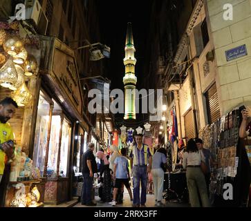 230818 -- BEIJING, Aug. 18, 2023 -- People gather at the Khan el-Khalili in Cairo, Egypt, July 28, 2023. Chongqing, a city by the Yangtze River, is called stove by Chinese people because of its high temperature in summer Cairo, located on the bank of the Nile, has long been a hot place on the edge of desert. Both cities have been vigorously promoting the night economy. Hongyadong in Chongqing is an ancient city gate that has been transformed into a giant suspended building featuring restaurants and other entertainment venues. Khan el-Khalili in Cairo, the centuries-old marketplace, is consider Stock Photo