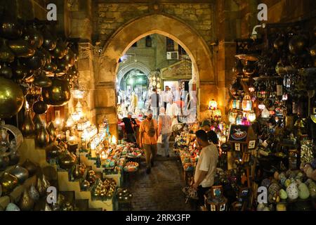 230818 -- BEIJING, Aug. 18, 2023 -- People gather at the Khan el-Khalili in Cairo, Egypt, July 28, 2023. Chongqing, a city by the Yangtze River, is called stove by Chinese people because of its high temperature in summer Cairo, located on the bank of the Nile, has long been a hot place on the edge of desert. Both cities have been vigorously promoting the night economy. Hongyadong in Chongqing is an ancient city gate that has been transformed into a giant suspended building featuring restaurants and other entertainment venues. Khan el-Khalili in Cairo, the centuries-old marketplace, is consider Stock Photo