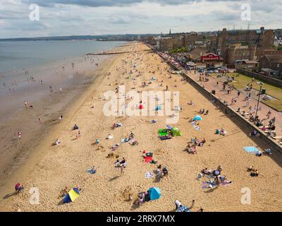 Edinburgh, Scotland, UK. 9th September 2023.  Aerial view of Portobello Beach outside Edinburgh which was busy with visitors making the most of unseasonable warm sunny weather in September. Temperatures rose to 26C in Edinburgh on Saturday. Iain Masterton/Alamy Live News Stock Photo