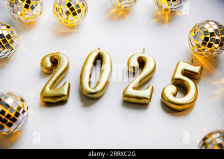 Text 2025. Happy New Year. Holiday card with a lighting garland like a mirror disco ball Stock Photo