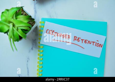 Concept of Customer Retention write on sticky notes isolated on Wooden Table. Stock Photo